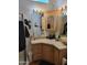 Well-lit bathroom features a vessel sink, decorative mirror, and a cabinet for storage at 2260 S Seminole Dr, Apache Junction, AZ 85119