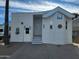 Charming home featuring a covered entry, white siding, tasteful accents, and a well-manicured front yard at 2260 S Seminole Dr, Apache Junction, AZ 85119
