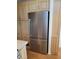 Kitchen area featuring modern stainless steel refrigerator and ample light wood cabinet space at 2260 S Seminole Dr, Apache Junction, AZ 85119