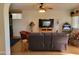 Comfortable living room featuring hardwood floors, modern furnishings, and a large entertainment center at 2260 S Seminole Dr, Apache Junction, AZ 85119