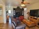 Bright living room with hardwood floors, comfortable leather seating, and a modern entertainment center at 2260 S Seminole Dr, Apache Junction, AZ 85119