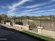 Back yard with view of golf course. Includes hardscape, small grass area, and some rock at 22988 W Twilight Trl, Buckeye, AZ 85326