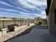 Back yard with view of golf course. Includes hardscape, small grass area, and some rock at 22988 W Twilight Trl, Buckeye, AZ 85326