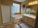 Bathroom featuring double sinks, a separate shower, a tub, and a decorative window at 22988 W Twilight Trl, Buckeye, AZ 85326