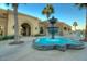 Upscale community fountain with turquoise water and palm trees in the background at 22988 W Twilight Trl, Buckeye, AZ 85326