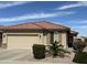 Charming single-story home featuring a tile roof, two-car garage, and desert landscaping at 22988 W Twilight Trl, Buckeye, AZ 85326
