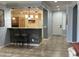 Kitchen breakfast bar with pendant lighting and tile flooring leading to the front entrance at 22988 W Twilight Trl, Buckeye, AZ 85326