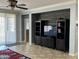 Living room featuring a mounted TV with a bookshelf and a sliding glass door at 22988 W Twilight Trl, Buckeye, AZ 85326