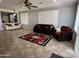 Open-concept living room with tile flooring, neutral walls, and comfortable seating at 22988 W Twilight Trl, Buckeye, AZ 85326