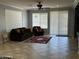 Spacious living room with tile flooring, neutral walls, and bright natural light at 22988 W Twilight Trl, Buckeye, AZ 85326