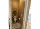 Small toilet room with a white toilet, flower decor, and a white plush rug at 22988 W Twilight Trl, Buckeye, AZ 85326