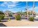 View of a peaceful street with mature trees, desert landscaping and mountain views in the background at 2301 E Christy Dr, Phoenix, AZ 85028