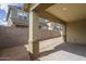 View of a spacious backyard with a covered patio and block wall, offering privacy at 23764 N 162Nd Ave, Surprise, AZ 85387