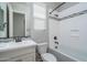 Bathroom with a white vanity, toilet, and shower-tub combo with decorative tile accents at 23764 N 162Nd Ave, Surprise, AZ 85387