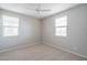 Bright bedroom with neutral carpet and three windows, offering ample natural light and a serene atmosphere at 23764 N 162Nd Ave, Surprise, AZ 85387