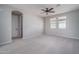 Spacious bedroom with carpeted floors, a ceiling fan, and windows for ample natural light at 23764 N 162Nd Ave, Surprise, AZ 85387