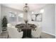 Well-lit dining room with a round table set for six and modern artwork on the walls at 23764 N 162Nd Ave, Surprise, AZ 85387