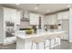Modern kitchen with white cabinets, granite countertops, stainless appliances, and an island with seating at 23764 N 162Nd Ave, Surprise, AZ 85387