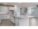 Open kitchen featuring white cabinets, granite countertops, and an island with a sink at 23764 N 162Nd Ave, Surprise, AZ 85387