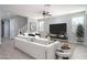 Cozy living room featuring a modern design, a large TV, and comfortable white seating at 23764 N 162Nd Ave, Surprise, AZ 85387