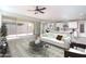 Staged living room with tile floors, neutral furniture, and backyard views through large sliding glass doors at 23764 N 162Nd Ave, Surprise, AZ 85387