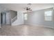 Large open living area with wood look tile floors, stairs to second level and ample natural light at 23764 N 162Nd Ave, Surprise, AZ 85387