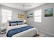 Staged main bedroom with blue bedding, side tables and lamps, creating a relaxing and inviting retreat at 23764 N 162Nd Ave, Surprise, AZ 85387