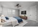 Main bedroom with a large bed, TV, ceiling fan, and natural light from multiple windows at 23764 N 162Nd Ave, Surprise, AZ 85387