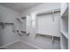 Spacious walk-in closet with white shelving and ample storage space, offering organization and convenience at 23764 N 162Nd Ave, Surprise, AZ 85387