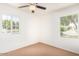 Neutral bedroom with carpet, ceiling fan, and dual windows at 2441 E Edgemont Ave, Phoenix, AZ 85008