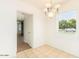 Bright dining room with large window, tile floor, and decorative chandelier lighting at 2441 E Edgemont Ave, Phoenix, AZ 85008
