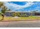 Charming home featuring a yellow door and a well-maintained front yard with mature landscaping at 2441 E Edgemont Ave, Phoenix, AZ 85008