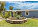 Home's landscaped front yard features a circular rock garden, a green lawn, and fresh plants and shrubbery at 2441 E Edgemont Ave, Phoenix, AZ 85008
