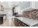 Modern kitchen featuring sleek cabinetry, granite countertops, stainless steel appliances, and a stylish tile backsplash at 2441 E Edgemont Ave, Phoenix, AZ 85008