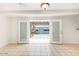 The large, tiled living space flows out to a charming pergola-covered backyard through glass patio doors at 2441 E Edgemont Ave, Phoenix, AZ 85008