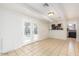 Bright living area with white walls, beamed ceilings and tile flooring open to updated kitchen area at 2441 E Edgemont Ave, Phoenix, AZ 85008