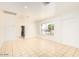 Bright living room with neutral paint, tile flooring, and a view to the landscaped front yard at 2441 E Edgemont Ave, Phoenix, AZ 85008