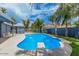 Private pool with diving board is surrounded by lush landscaping, a pergola-covered patio and privacy fencing at 2441 E Edgemont Ave, Phoenix, AZ 85008