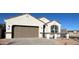 Inviting single-story home with a two-car garage and a well-manicured front yard at 25308 W Sunland Ave, Buckeye, AZ 85326