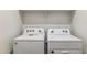 The laundry room has a Whirlpool washer and dryer, and a shelf overhead at 25308 W Sunland Ave, Buckeye, AZ 85326