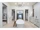 Bright bathroom featuring a standalone tub, walk-in shower, dual walk-in closets, and elegant chandelier at 27914 N 100Th Pl, Scottsdale, AZ 85262