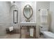 Modern bathroom featuring a stone tile shower, vanity with a bronze faucet, and a classic framed mirror at 27914 N 100Th Pl, Scottsdale, AZ 85262