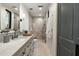 Modern bathroom features a glass shower, stone counter vanity, black fixtures, and access to the bedroom at 27914 N 100Th Pl, Scottsdale, AZ 85262