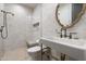 Elegant bathroom features a glass enclosed shower, stylish vanity, toilet, and an ornate mirror at 27914 N 100Th Pl, Scottsdale, AZ 85262