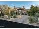 Inviting home entrance with a paved driveway and lush desert landscaping at 27914 N 100Th Pl, Scottsdale, AZ 85262