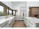 A bright kitchen featuring white cabinetry, stainless steel appliances, a farmhouse sink, and a large window at 27914 N 100Th Pl, Scottsdale, AZ 85262
