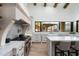 Bright kitchen features stainless steel appliances, ample storage space, and a large window overlooking the outdoor space at 27914 N 100Th Pl, Scottsdale, AZ 85262