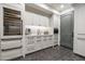 Charming kitchenette with stainless steel appliances, custom cabinetry, and unique herringbone flooring at 27914 N 100Th Pl, Scottsdale, AZ 85262