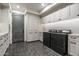 Well-equipped laundry room with modern washer/dryer, custom cabinets, and stylish herringbone flooring at 27914 N 100Th Pl, Scottsdale, AZ 85262