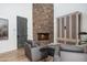 Living room with a stone fireplace and comfortable seating at 27914 N 100Th Pl, Scottsdale, AZ 85262